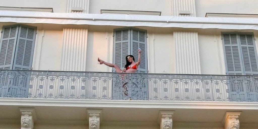 Katy Perry Does Hotel Balcony High Kick in Bright Orange Bikini